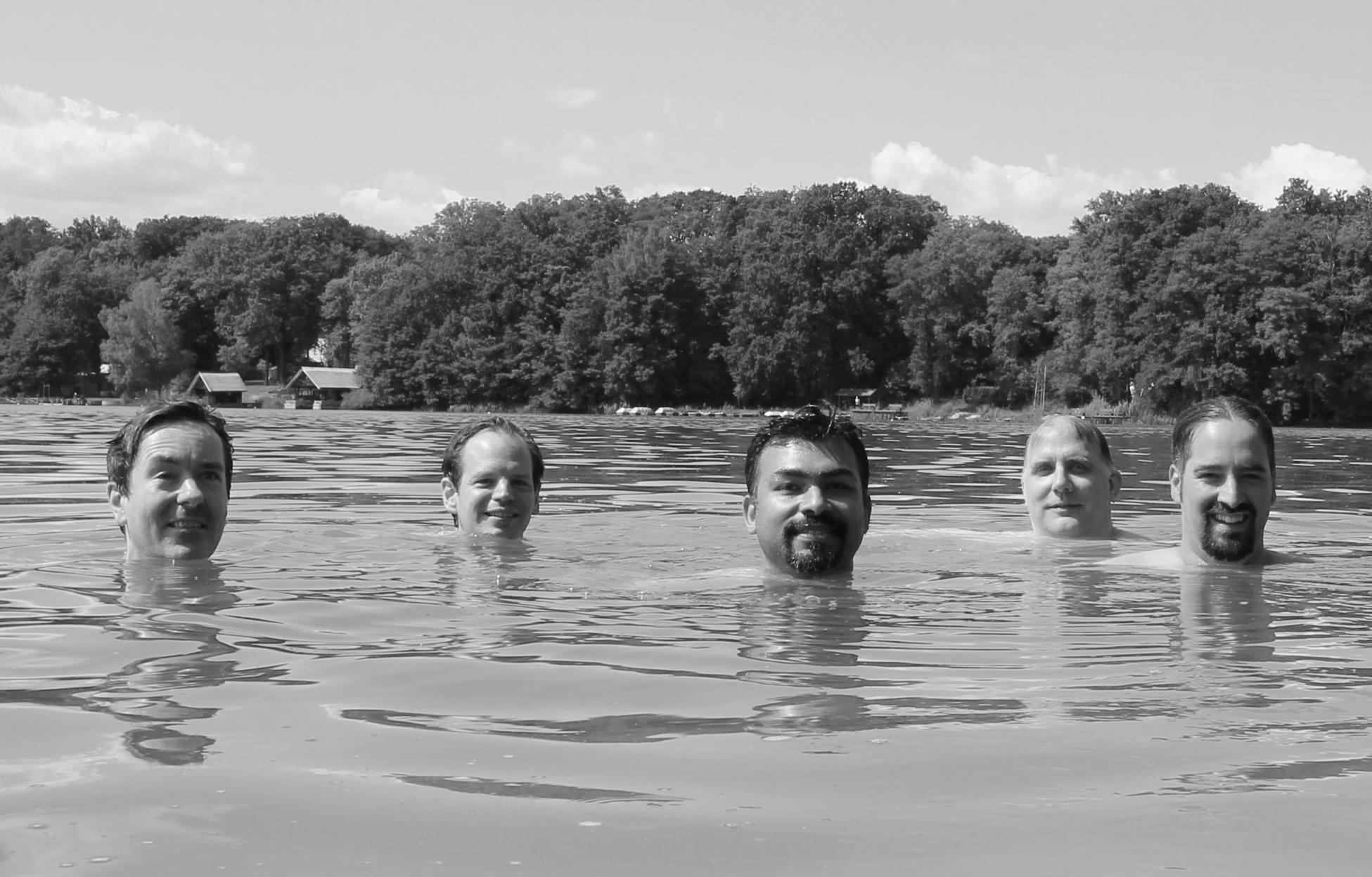 Slint team swimming in a lake