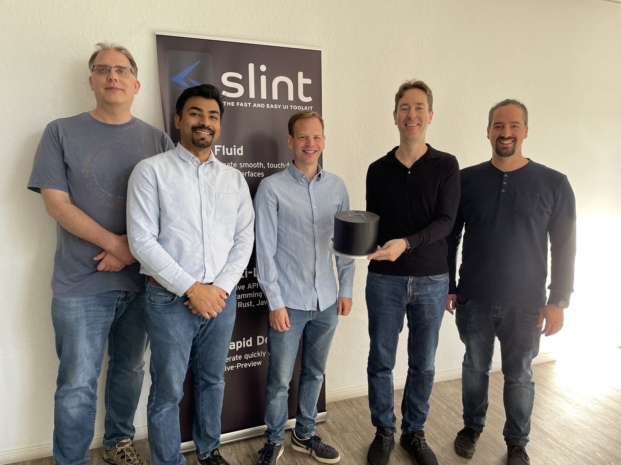 Slint team with cake